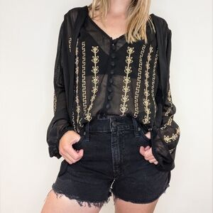 Sheer black top with tie collar and gold embroidery